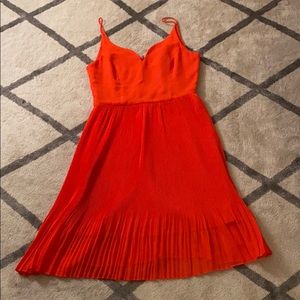 Knee length pleat fit and flare orangey dress